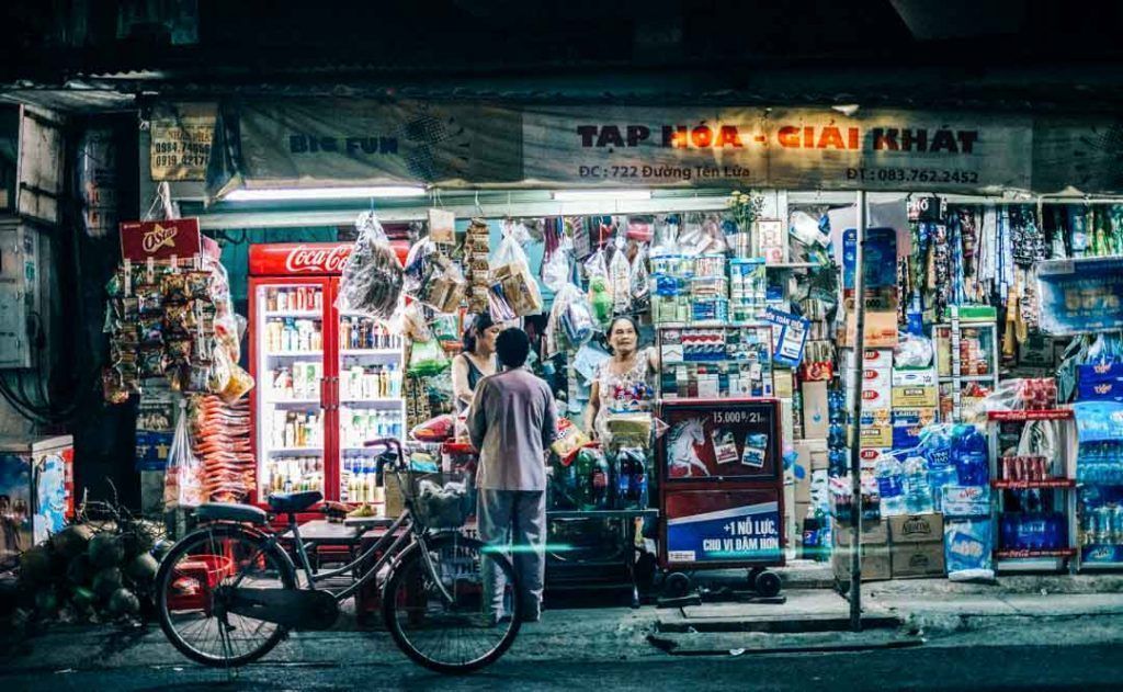Tienda de barrio iluminada de noche en Saigón, una escena cotidiana con encanto que ver en Ho Chi Minh en 1 dia.