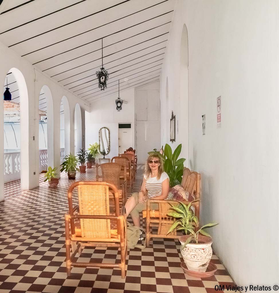 Servidora descansando en la galería con arcos del Hotel Casa Morey en Iquitos, un alojamiento con encanto que ver en Iquitos.