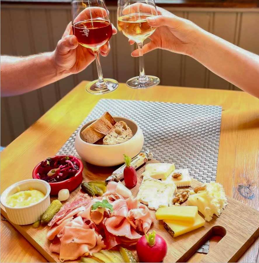 Tabla de quesos, embutidos y vino alsaciano en un restaurante, una opción perfecta para tapear si buscas donde comer en Colmar.