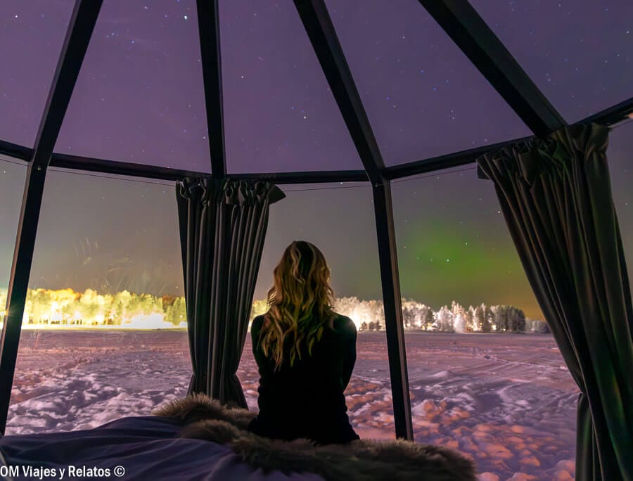 Foto mía observando la aurora boreal desde nuestro iglú de cristal, una experiencia única para ver auroras boreales en Rovaniemi.