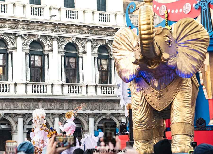 Elefante dorado en desfile del Carnaval de Venecia frente a palacios históricos, un espectáculo que hacer en Venecia en Carnaval.