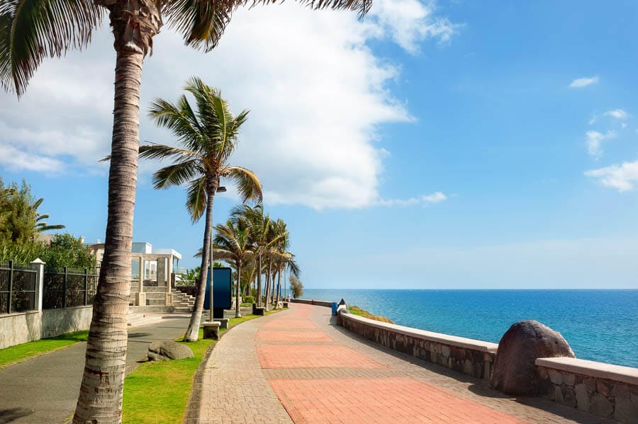 Paseo marítimo de Maspalomas junto al océano y las palmeras, uno de los rincones agradables que ver en Maspalomas.