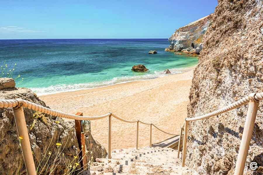 Escalera de acceso a la playa de Paliochori, rodeada de acantilados y mar turquesa, una de las mejores playas de Milos.