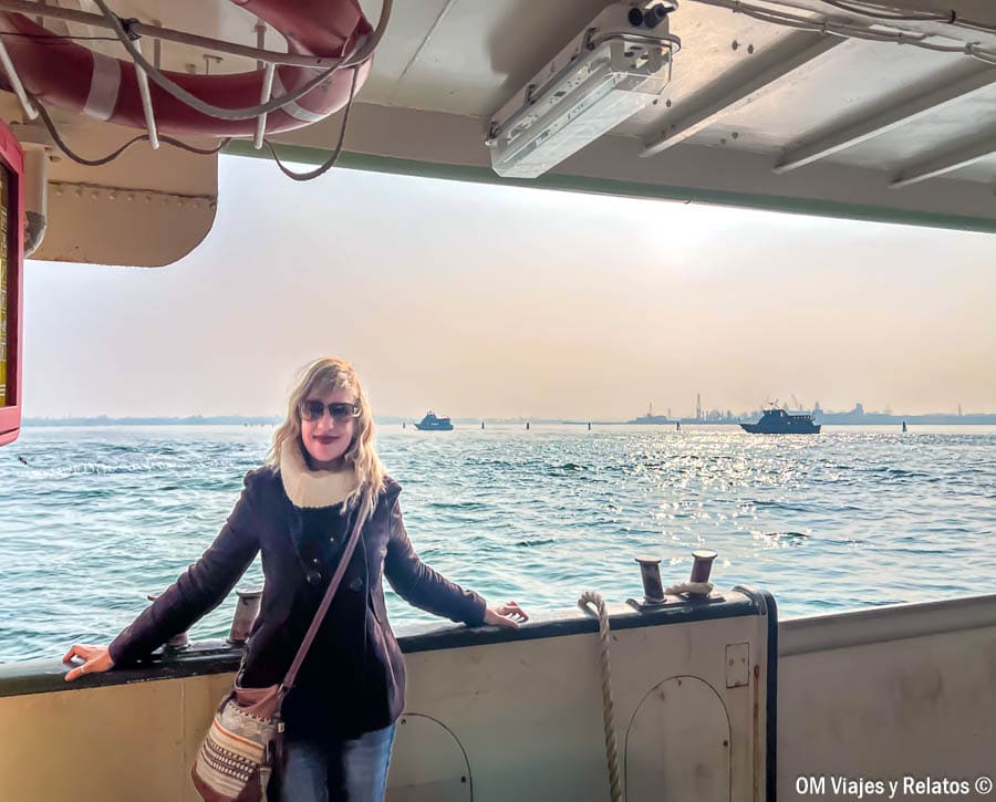 Una servidora en el barco camino a Burano con la laguna de Venecia al fondo, una experiencia recomendada en que ver en Burano.