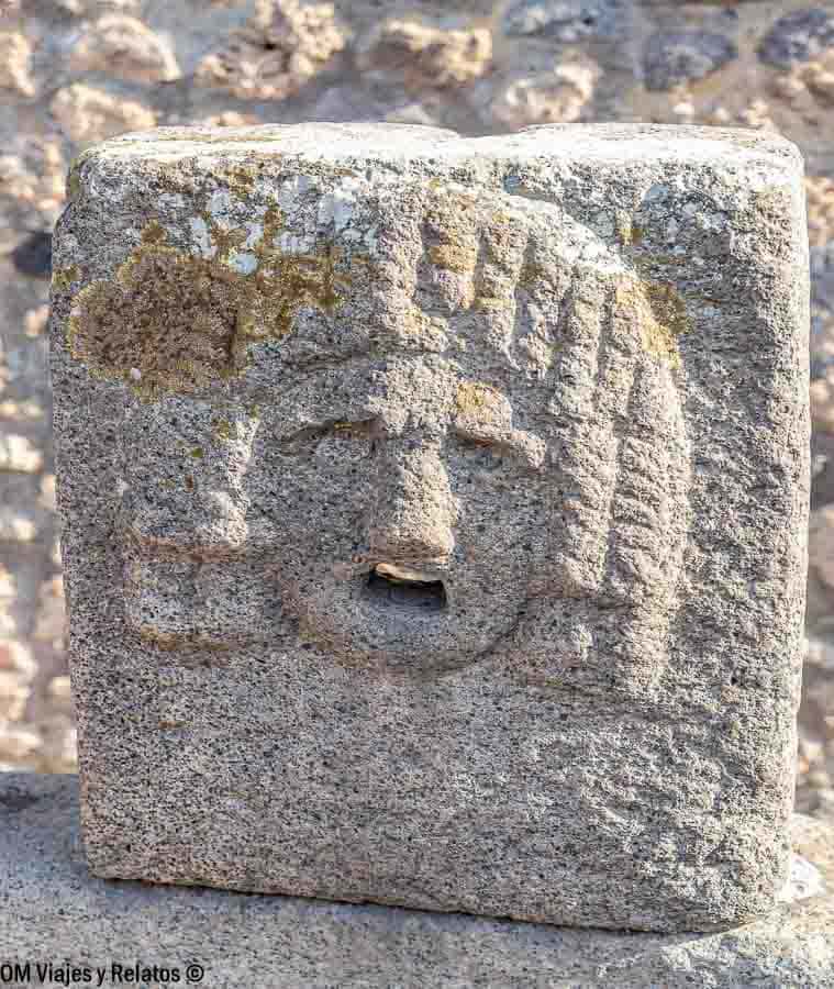 Fuente de piedra con rostro tallado en Pompeya, un detalle arqueológico curioso al planificar como ir de Roma a Pompeya.