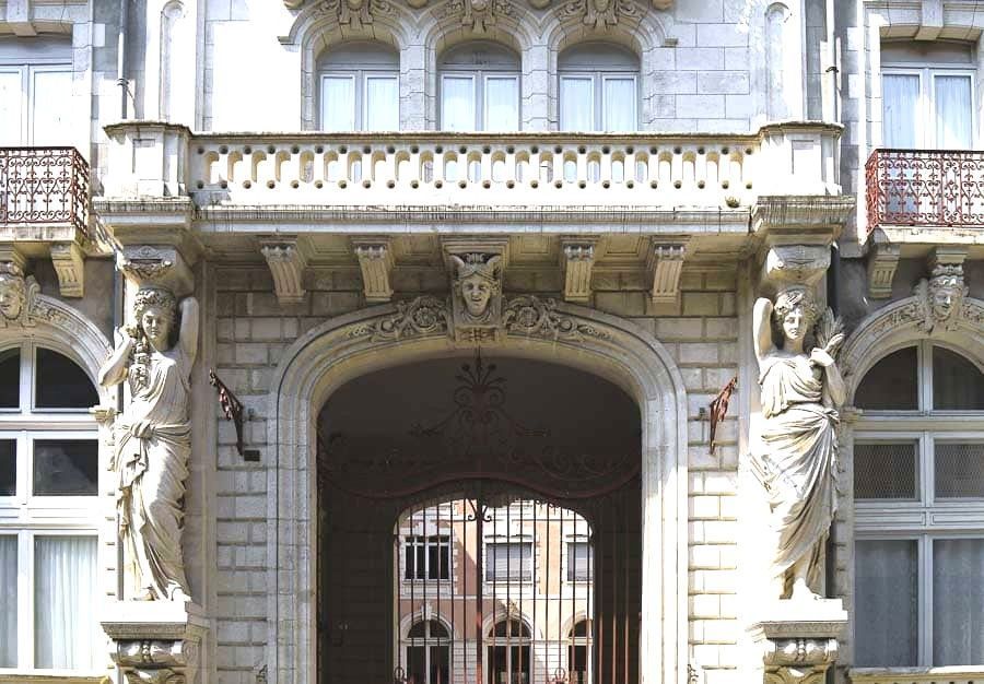Antigua fachada del Gran Hotel Continental en Cauterets con arco monumental y esculturas tipo cariátides, un detalle arquitectónico de los pueblos más bonitos del Pirineo Francés.