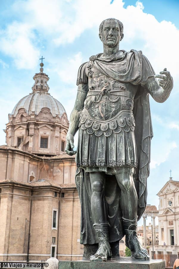 Estatua de un personaje romano con una cúpula histórica al fondo, un imprescindible en que ver en Roma en 4 dias.