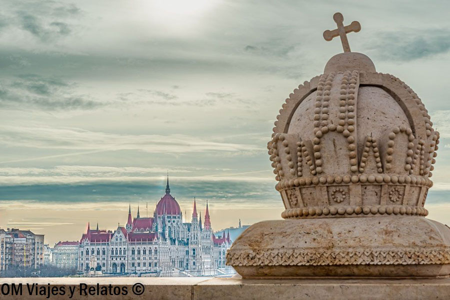 Parlamento de Budapest junto a una corona decorativa, una imagen imprescindible para una visita al Parlamento de Budapest.
