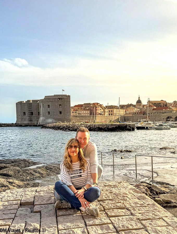 Foto en pareja de OM Viajes y Relatos disfrutando del atardecer frente a las murallas de Dubrovnik durante una ruta por Croacia en 7 días.