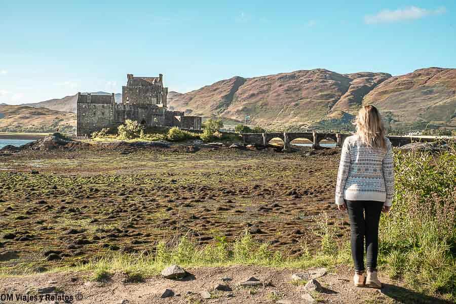 Foto mía frente al castillo de Eilean Donan, uno de los lugares imprescindibles que ver en Escocia en 7 días.