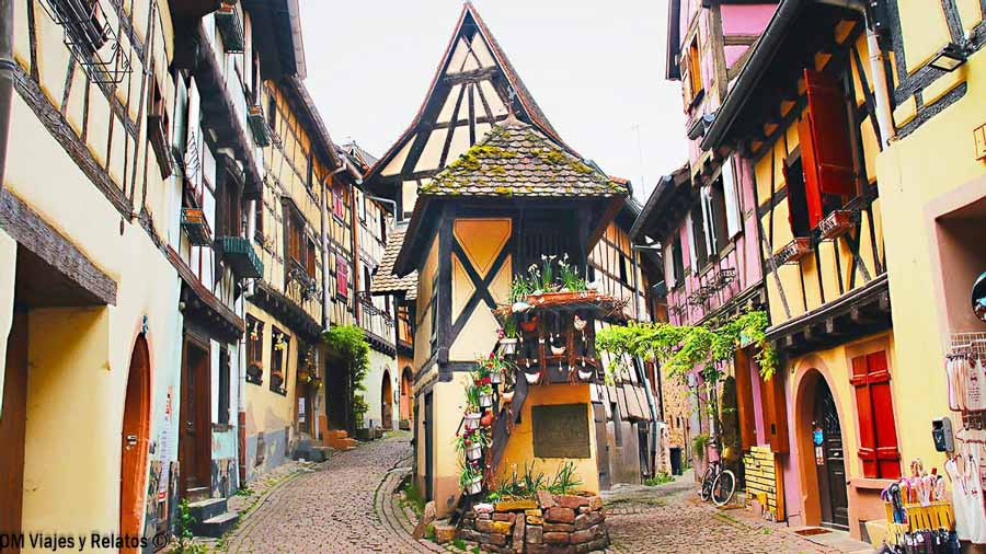 Calle de Eguisheim con casas tradicionales de entramado de madera en Alsacia