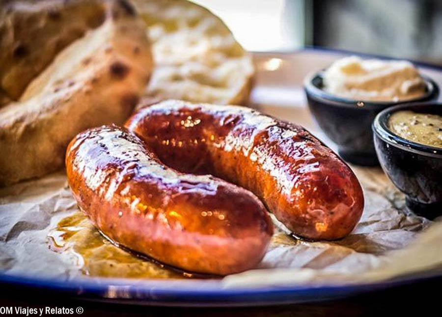 Salchichas servidas con pan y salsas durante una comida en Praga