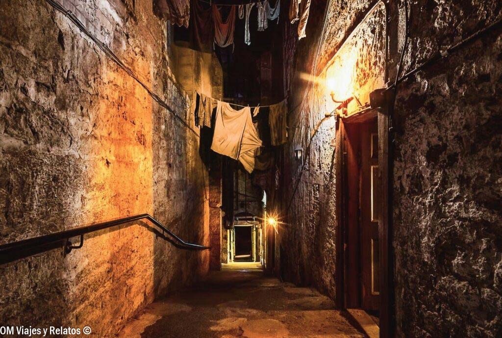 Interior de un close histórico de la Royal Mile de Edimburgo, con pasadizo de piedra y ropa tendida