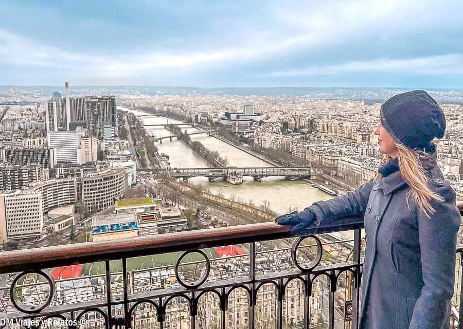 Servidora contemplando las vistas panorámicas del río Sena y los puentes de París desde el mirador de la Torre Eiffel