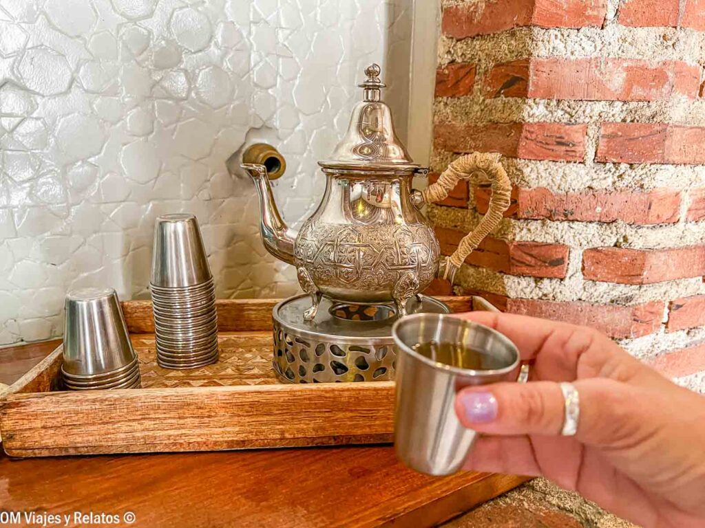 Servicio de té moruno en Hammam Al Ándalus Madrid, con una tetera tradicional de metal y vasos de té